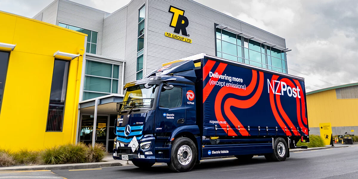 Mercedes-Benz eActros Electric Curtainside 4x2 2023 - TR Group's 50th sustainable vehicle - in front of TR Group building in Auckland.